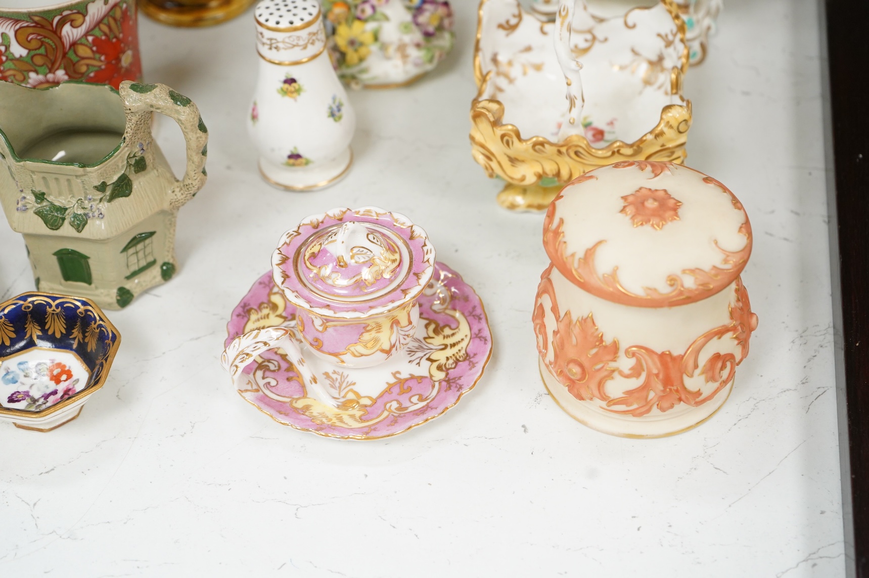 Large group of 19th/20th century English ceramics, to include a Rockingham basket, other English porcelain flower encrusted vessels, a Copeland and Garrett ewer, a Minton Sevres style beaker, a Wedgwood agate ware jug, R